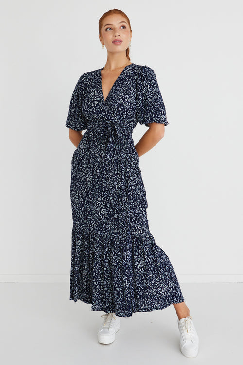 model wears a navy floral maxi dress