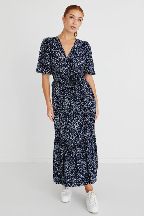 model wears a navy floral maxi dress