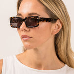 model wears brown sunglasses