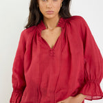 Woman wearing a red blouse with a white background