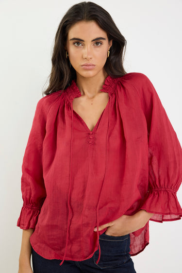 Woman wearing a red blouse with a white background