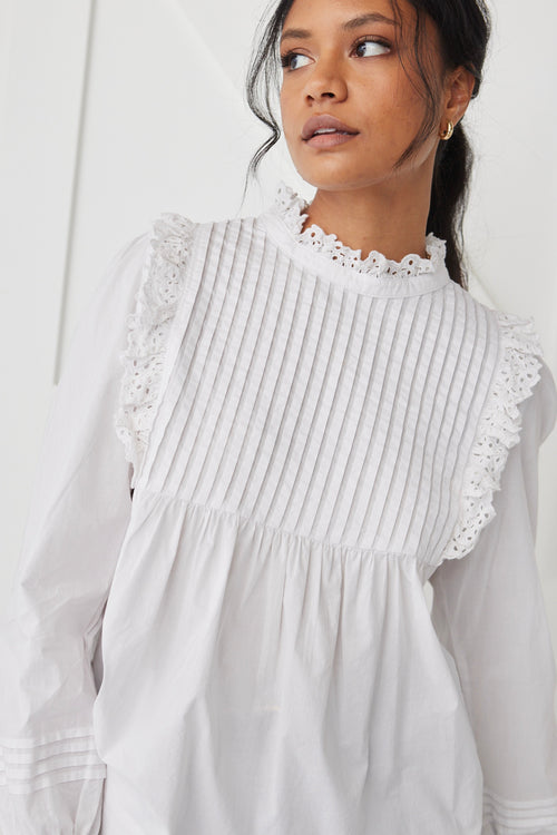 model wears a White High Neck Blouse