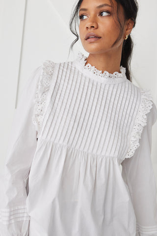 model wears a White High Neck Blouse