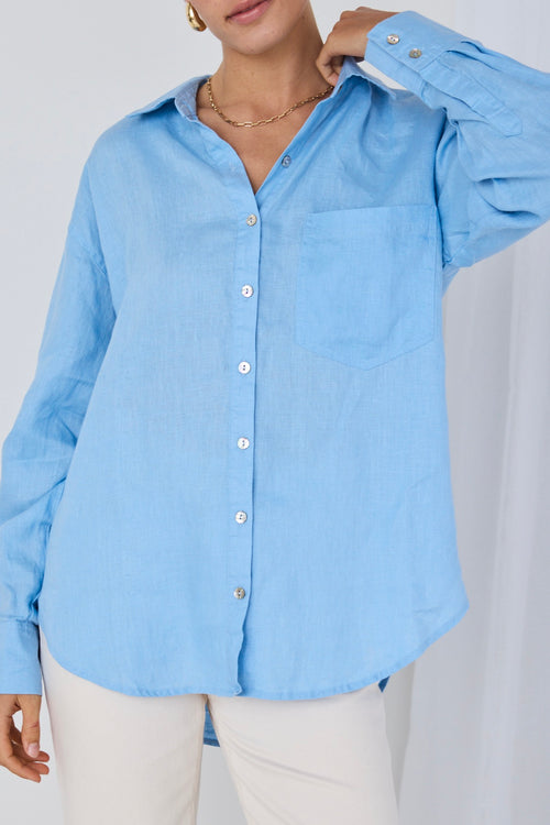 model wears a blue linen shirt