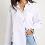 model wears a white linen shirt