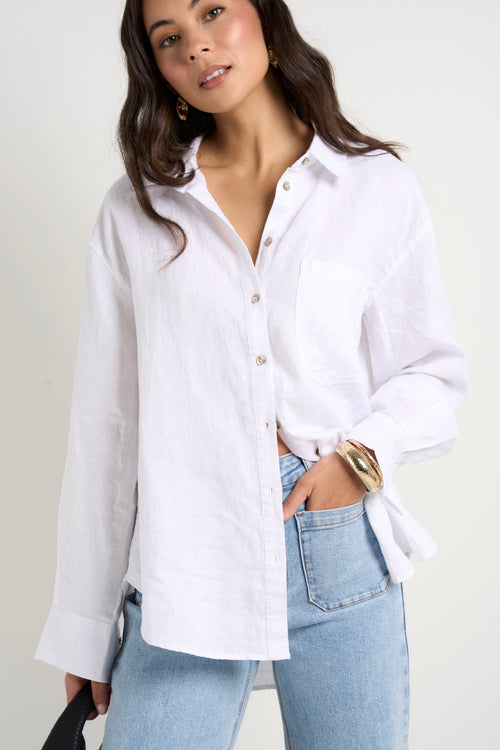 model wears a white linen shirt