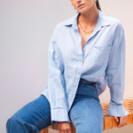 model wears a blue linen shirt