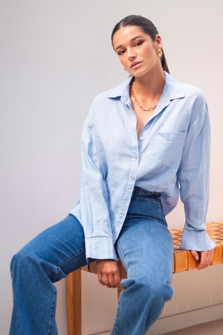 model wears a blue linen shirt