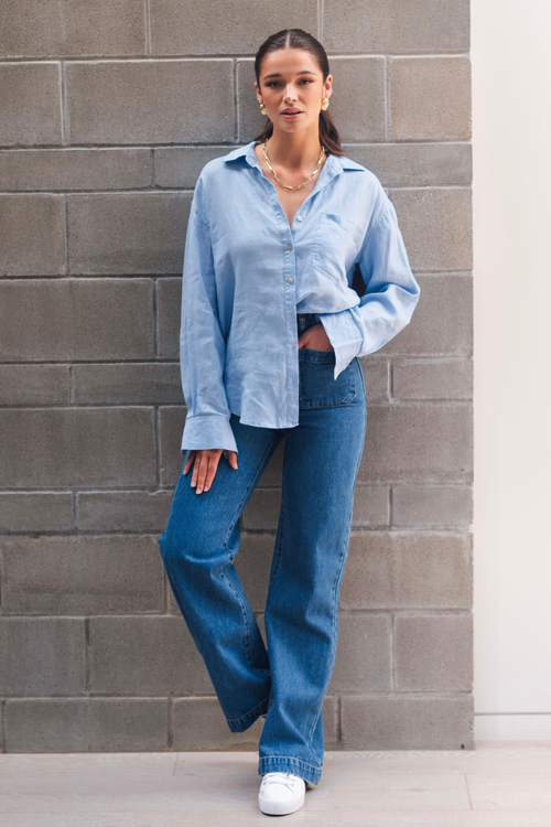 model wears a blue linen shirt