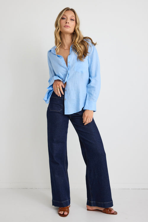 model wears a blue linen shirt