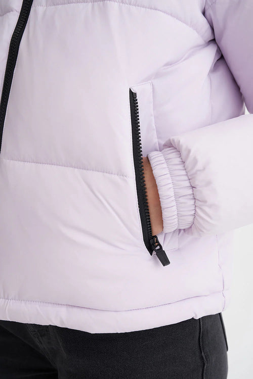 model wears a purple puffer jacket