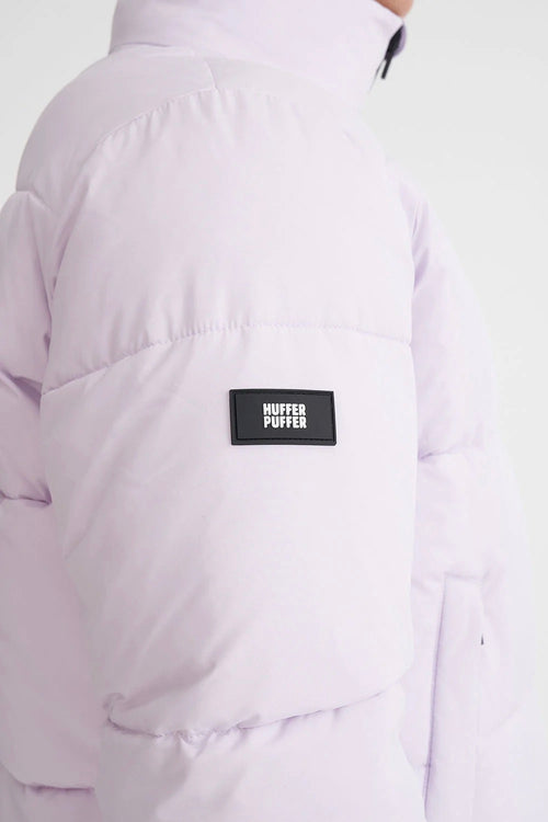 model wears a purple puffer jacket