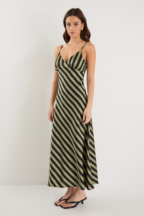 model wears a black and khaki stripe maxi dress with black heels 