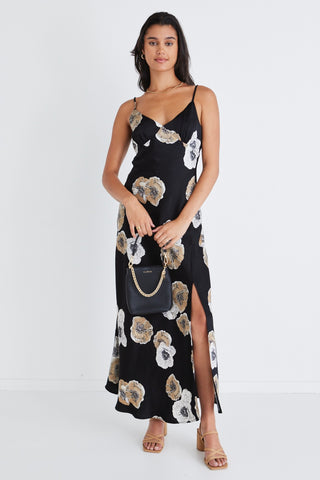 model wears a black floral dress