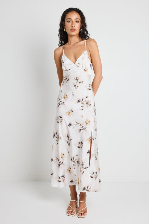 model wears a white floral satin maxi dress