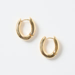 A pair of small oval-shaped wavy gold hoop earrings photographed on a clean white background.