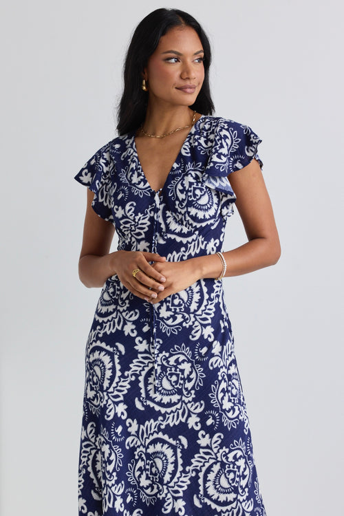 model wears a navy print midi dress