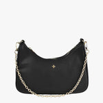 A small black vegan leather shoulder bag with a soft pebble texture, featuring a curved silhouette, gold-tone zip closure, and a short gold chain strap. The front of the bag is adorned with a subtle gold cross logo.