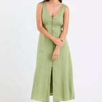 Woman wears a green button down front dress