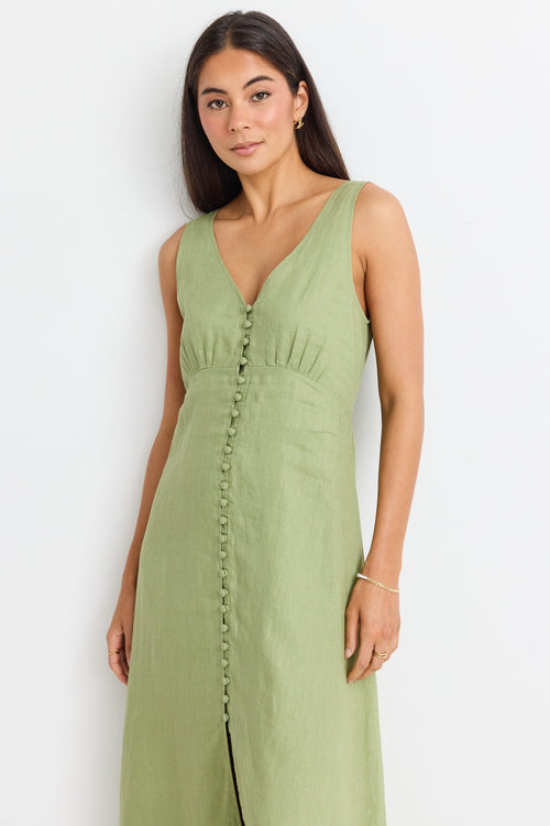 model wears a green linen midi dress