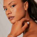 Model wears a silver chain bracelet 