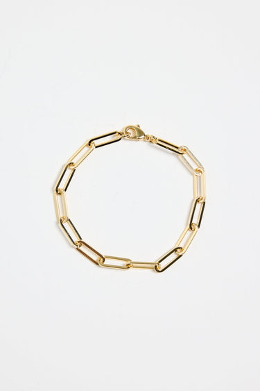 gold-plated brass paperclip chain bracelet with elongated links, photographed flat on a white background.