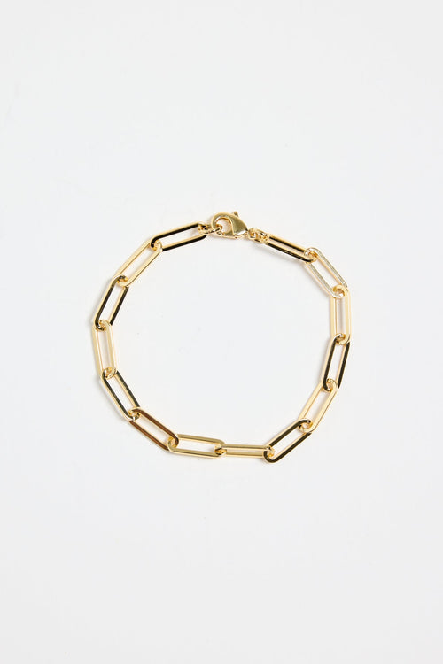 gold-plated brass paperclip chain bracelet with elongated links, photographed flat on a white background.