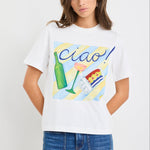 Woman wearing a white t-shirt with colorful graphics and 'Ciao' text on a plain background