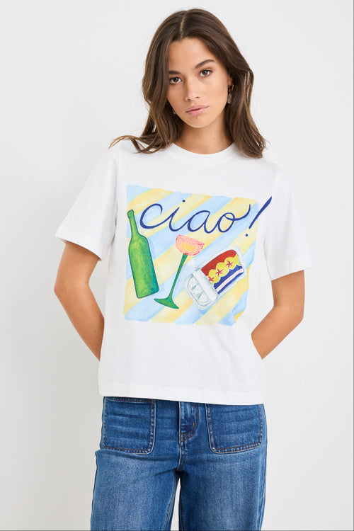 Woman wearing a white t-shirt with colorful graphics and 'Ciao' text on a plain background