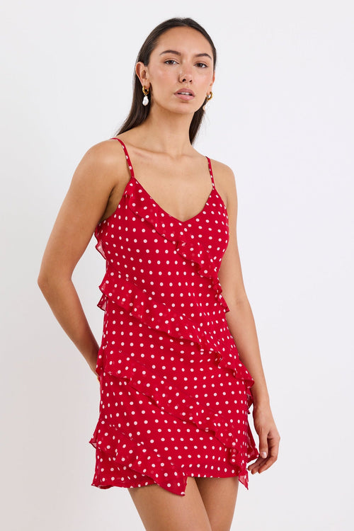 Woman wearing a mini red white polka dot ruffle dress