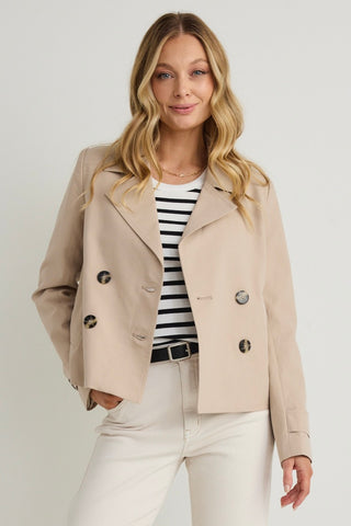 model wears a beige coat