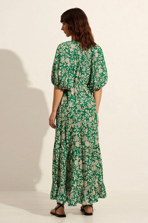 Model wears green floral maxi dress