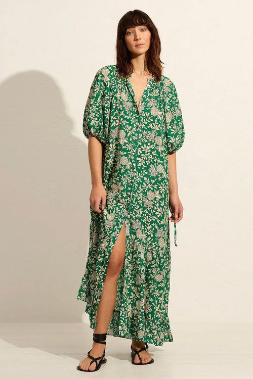 Model wears green floral maxi dress