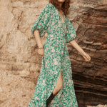 Model wears green floral maxi dress