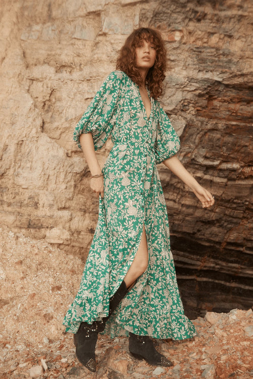 Model wears green floral maxi dress