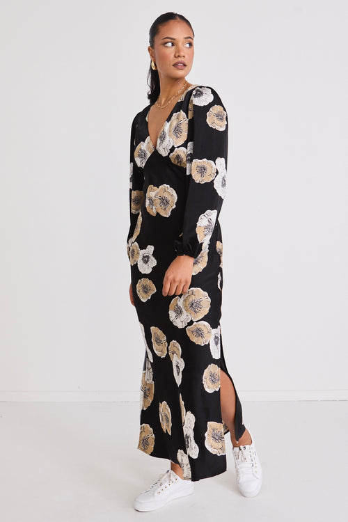 model wears a black floral maxi dress