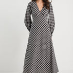 Woman wearing a black and white checkered dress on a white background