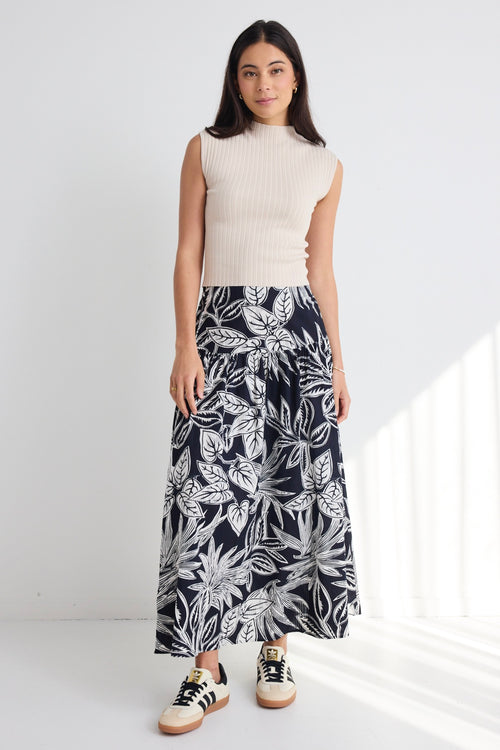 model wears a navy white floral maxi skirt