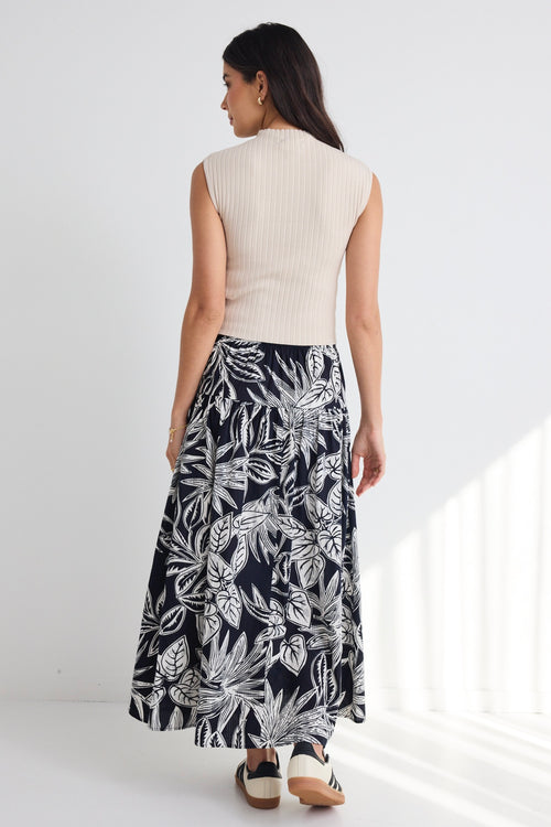 model wears a navy white floral maxi skirt