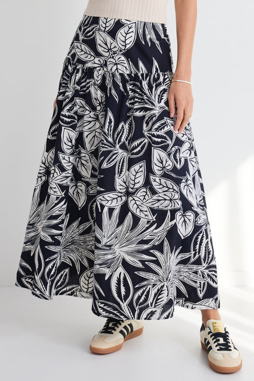 model wears a navy white floral maxi skirt