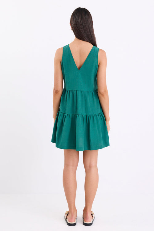 Woman wearing a green dress on a white background