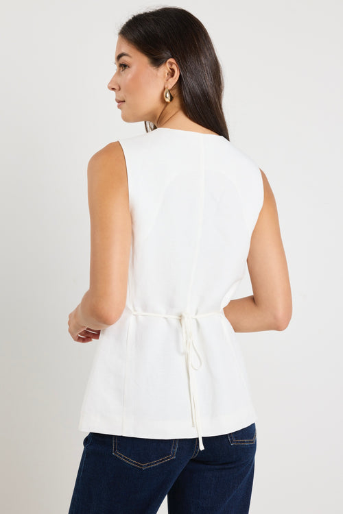 model wears a white linen vest 