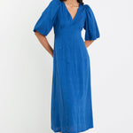 Woman wearing a blue dress on a white background