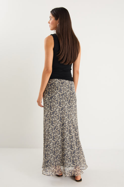model wears a leopard maxi skirt with a black tank top