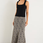 model wears a leopard maxi skirt with a black tank top