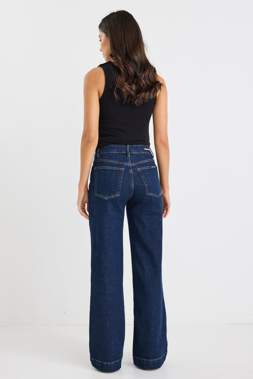 model wears dark blue wide leg jean