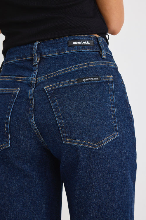 model wears dark blue wide leg jean