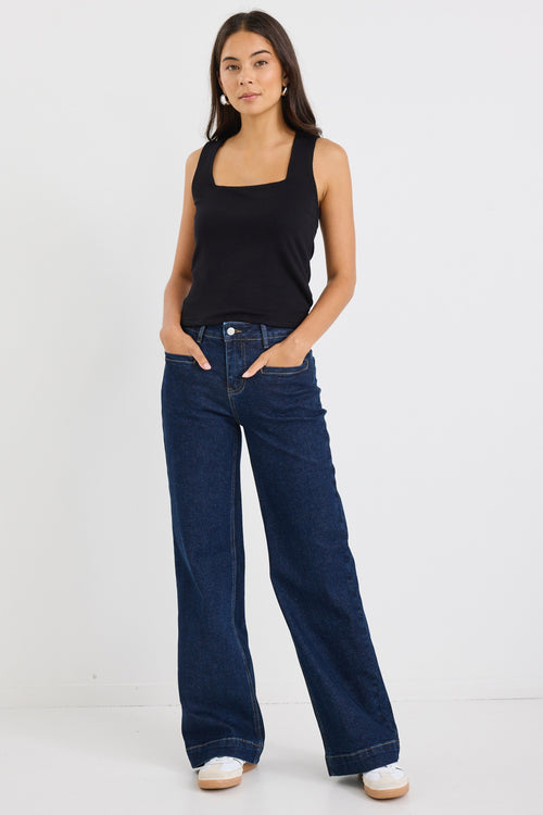 model wears dark blue wide leg jean