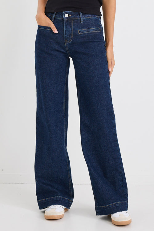 model wears dark blue wide leg jean