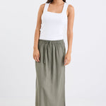 Woman wearing a khaki skirt and white top